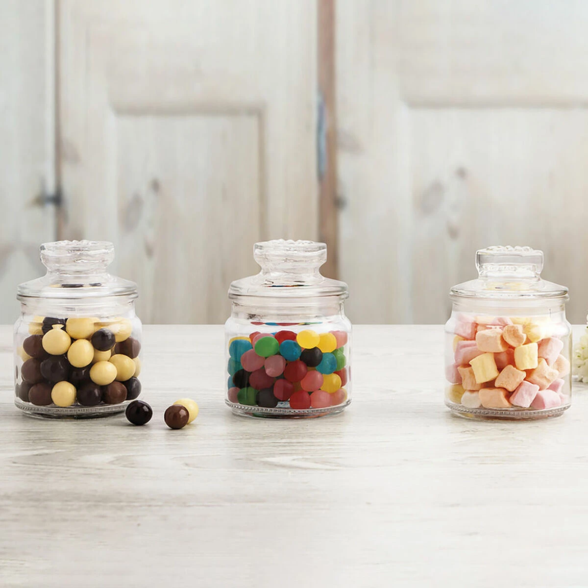 Three jars of colorful candy