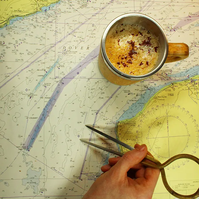 Cup of coffee on a maritime map of the English Channel