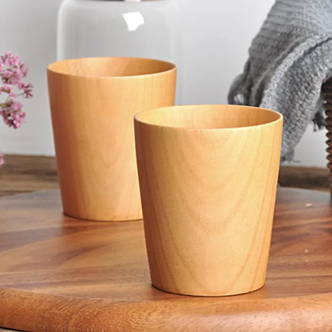 2 cups, wooden cups on a table